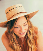 Load image into Gallery viewer, handmade hat woven with palm on woman
smiling
