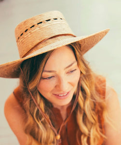 handmade hat woven with palm on woman
smiling