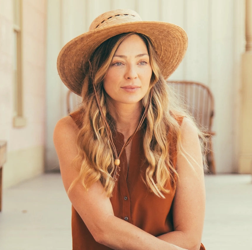 handmade hat woven with palm on woman
smiling